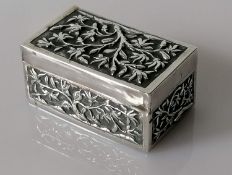 An early 20th century Chinese oblong silver snuff box decorated in relief with prunus blossoms by