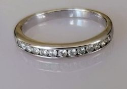 A diamond half-hoop eternity ring, the 18ct white gold band set with thirteen round brilliant-cut