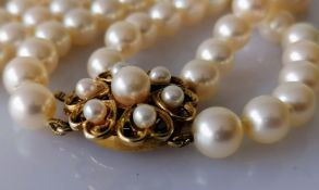 A knotted two-row cultured rope necklet with 109 and 104 approximately, 7mm pearls united by a 9ct