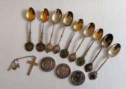 A selection of silver presentation teaspoons, three silver medals, a silver bangle and a crucifix