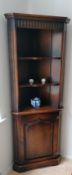A Royal Oak Furniture Company Balmoral range corner unit with arcaded carved design, shelved