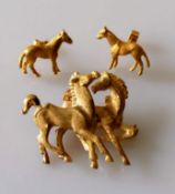 A gold brooch depicting two prancing horses, unmarked, tests for 14ct, 35 x 40mm, 11.47g and a
