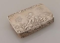 A 19th century oblong 800 silver pill or snuff box of oblong form with embossed cupids in a