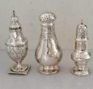 A George III silver caster of urn form with repousse floral decoration on a square base, 15 cm H;