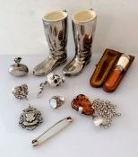 An assortment of silver bibelots to include a scent bottle, moonstone ring, articulated silver scull