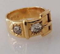 A Victorian 18ct gold buckle ring with two old mine-cut diamonds, approximately 0.50 carats (