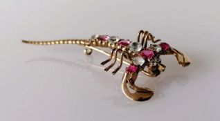 A ruby and white sapphire scorpion brooch on a gold base, 5.5 cm, unmarked, approximately 0.60