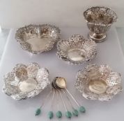A pair of late Victorian silver pierced bon-bon dishes with profuse rococo vine decoration in relief
