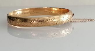 A mid-century 9ct yellow gold bangle with etched decoration, inscription to inside, import marks,