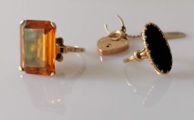 A gem-set dress ring in a gold claw setting, size P, stamped 9ct; an elliptical platform onyx ring