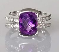 An amethyst and diamond ring, cushion-shape mixed-cut 10.6mm x 8.11mm, depth 5.49mm, calculated 2.95