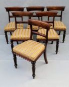 A set of six George IV mahogany-framed dining chairs with carved support, fabric upholstery, on flut