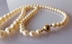 A mid-century single row of sixty-nine graduated Akoya cultured pearls measuring 6mm to 9.7mm