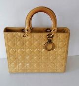 A Christian Dior Lady MM bag in yellow cannage quilted fabric with gold tone hardware, double top ha