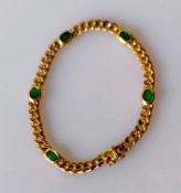 An 18ct yellow gold flat curb-link bracelet with oval emerald decoration, box clasp, 17.5 cm, stampe