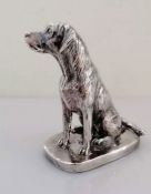 A silver model of a seated Labrador on an oblong base, signed Donaldson, 10.5 cm H,