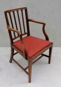 A Georgian mahogany-framed carver chair with spindle supports, drop-in seat on stretcher supports