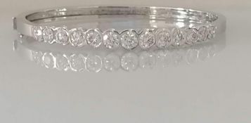 A diamond hinged bangle, set with thirteen round brilliant-cut diamonds