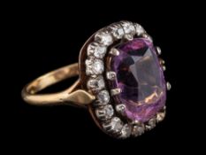 An amethyst and diamond ring,: the cushion shaped amethyst within a surround of old cut diamonds,