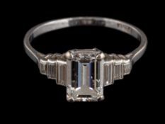 A platinum diamond ring,: the emerald cut diamond stated to weigh 1.