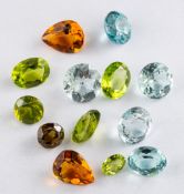 A group of unset gemstones,: including peridot; aquamarine; citrine; and others.