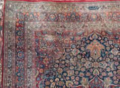 A Meshed carpet:, the indigo field with a central flowerhead pole medallion in red,