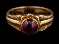 An amethyst ring,: the circular cabochon amethyst in a collet setting,