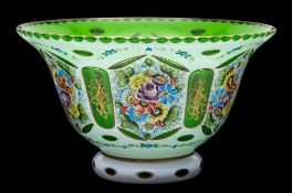 An overlay glass bowl: of flared form, in opaque white over a green stained ground,