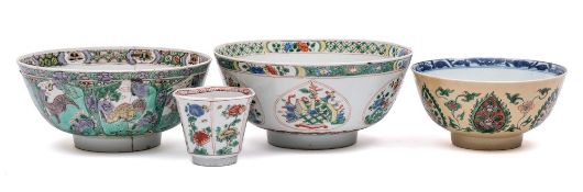 A group of three Chinese famille verte bowls and a teabowl: one with lotus medallion to the