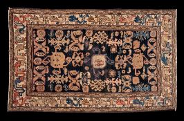 A Shirvan rug:, the indigo field with an all over design of hooked and boteh medallions,