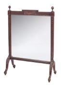 An Edwardian carved mahogany and glazed panel firescreen:,