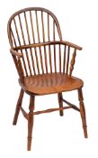 An ash and elm Windsor armchair, first half 19th century,: with arched toprail to the spindle back,