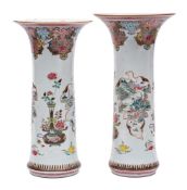 A large graduated pair of Chinese famille rose sleeve vases: finely enamelled with fruit,