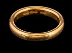 A 22 carat gold ring,: the plain polished band, stamped 22 with full Birmingham hallmarks for 1920,