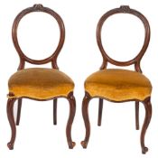 A set of six Victorian Pteridomania carved walnut and upholstered 'balloon back' dining chairs,