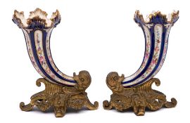 A pair of 19th century gilt-bronze and porcelain cornucopia vases: of fluted and flared outline