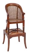 A child's early 19th Century mahogany bergere high chair:, on a stand,