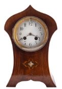 An Art Nouveau mahogany mantel clock: the eight-day duration movement striking the hours and