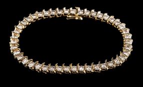 A diamond tennis bracelet,: set with a line of brilliant cut diamonds, approximately 7.