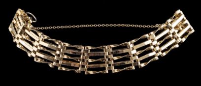 A gate link bracelet:, composed of polished panels, with a safety chain, missing clasp, 13.3g.