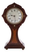 An Edwardian cartouche shaped clock: the eight-day duration timepiece movement having a platform