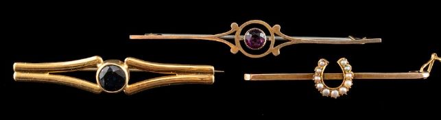 A 22 carat gold and sapphire brooch,: the circular cut sapphire in a collet setting,