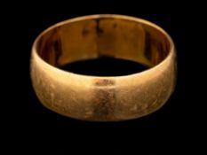 A 22 carat gold ring,: the plain polished band, stamped 22 with full Birmingham hallmarks for 1920,