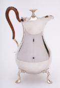 A George V silver hot water jug, maker Mappin & Webb, Sheffield, 1910: of pear-shaped outline,