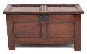 An early 18th Century oak rectangular coffer:, of small size and panelled construction,