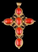 A gold coloured coral cross pendant,
