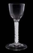 An English wine glass: the pointed funnel shaped bowl set on a double series opaque twist stem and