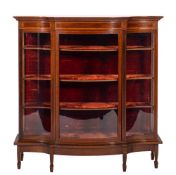 An Edwardian mahogany and inlaid serpentine-fronted display cabinet:, crossbanded in satinwood,