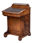 A Victorian walnut and inlaid bow-fronted Davenport:, crossbanded and bordered with boxwood lines,