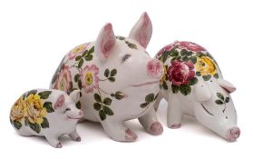 A group of three Exon Wemyss Ware pigs: modelled in seated and standing posture,